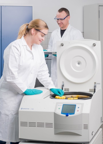 Scientists loading conical tubes into a Sigma 4-16KS compact performant refrigerated centrifuge