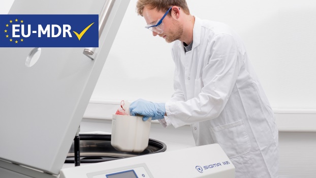 Lab technician loading blood bags into Sigma 8KBS, MD, package, floorstanding refrigerated centrifuge